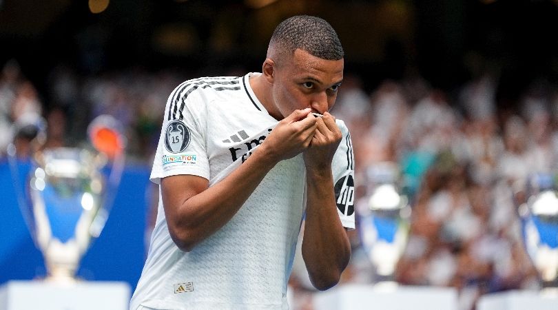 Kylian Mbappe kisses the badge on his Real Madrid shirt at his official presentation in July 2024.