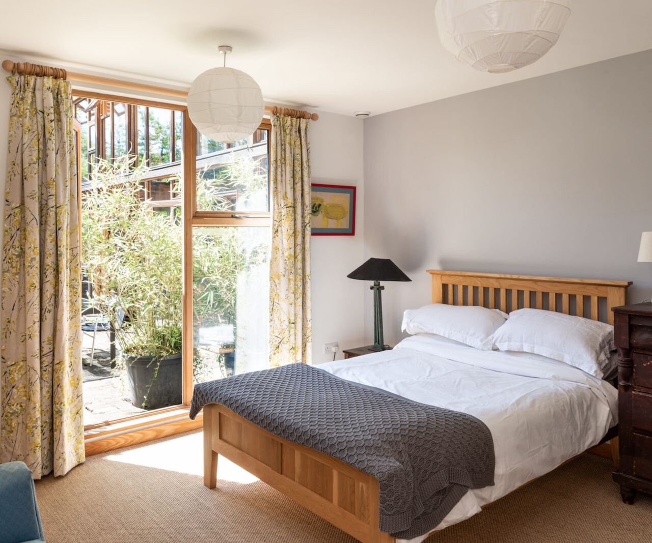 A bedroom connected to the garden through bifold doors
