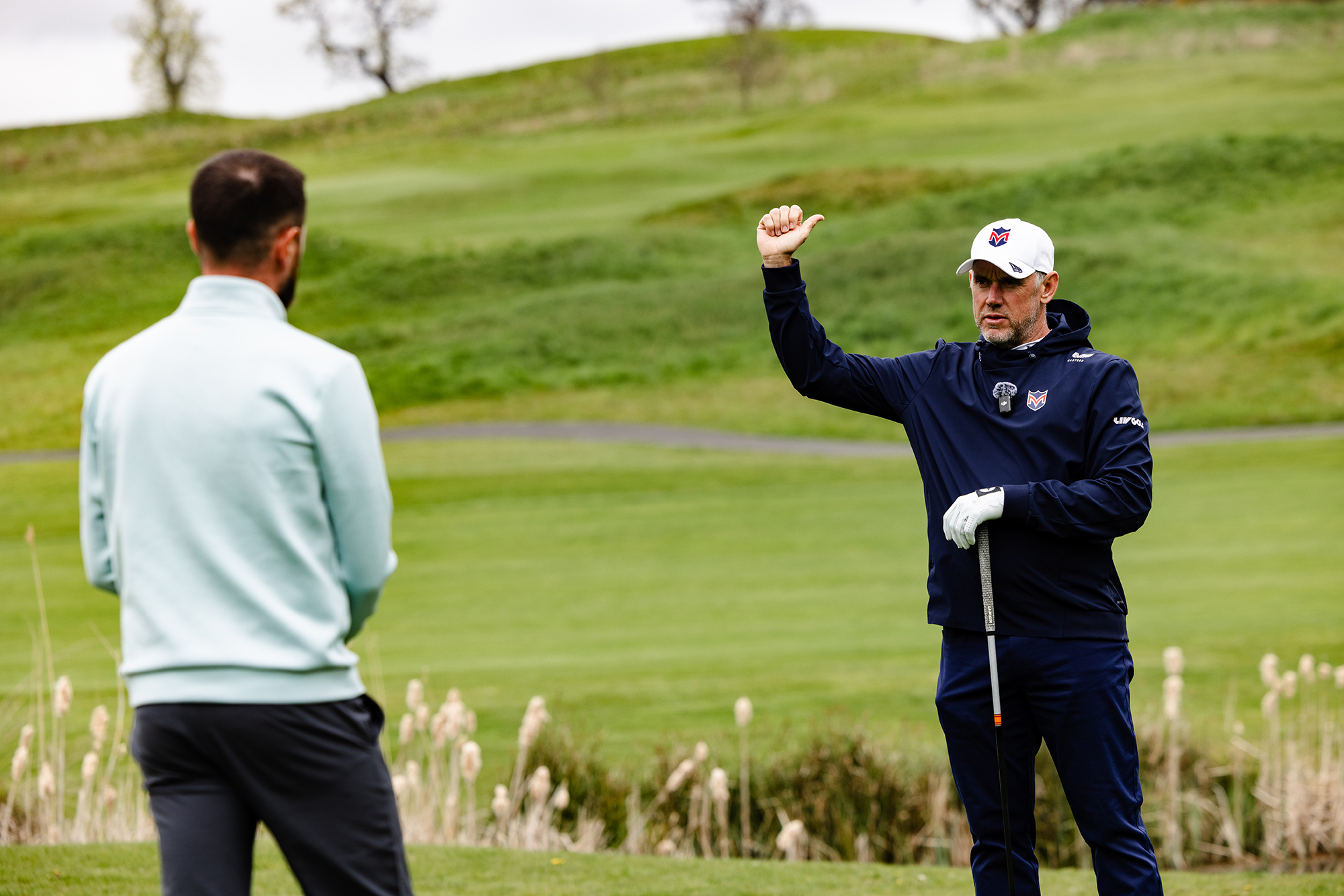 Lee Westwood demonstrating to Baz Plummer the need to connect the arms at the start of the downswing