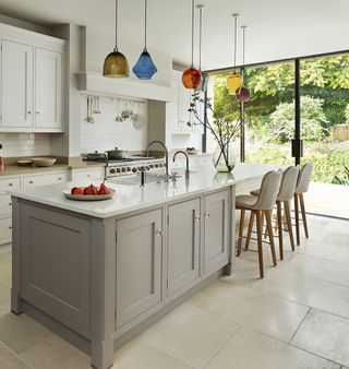 a kitchen island with mix and match pendant lights