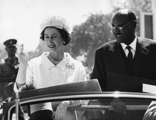 HM Queen Elizabeth II and President El Tigani El-Mahi, in a car together on the state drive from Khartoum Airport on a royal visit, Sudan, February 11th 1965.