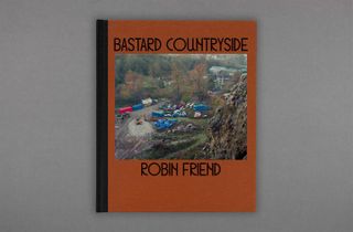 A photo of the "Bastar Countryside" by Robin Friend book. The book is orange with a photo and black font.