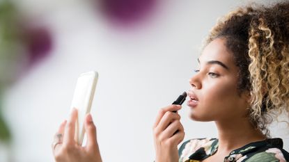 woman applying makeup