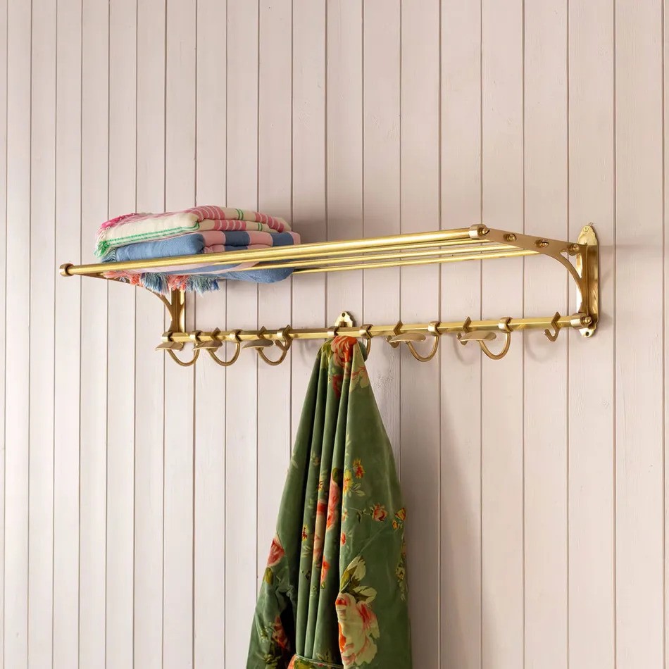 Gold fitted coat rail with towels