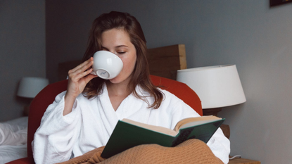 woman drinking tea in bed
