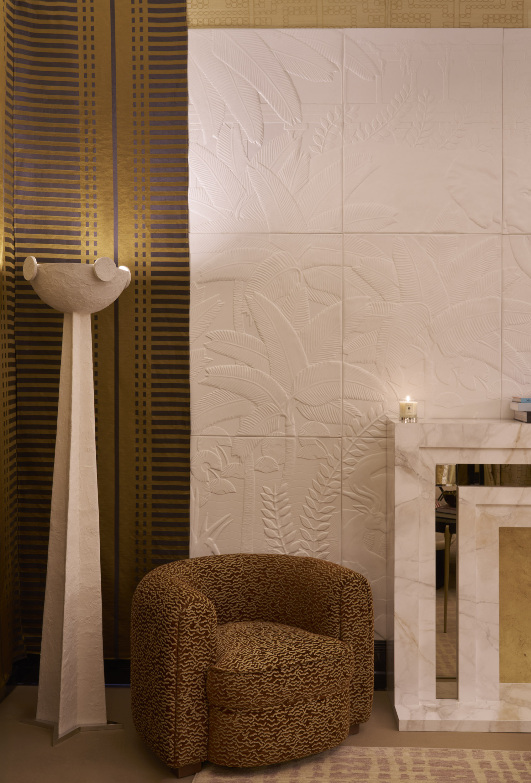 A series of interior shots of beautifully furnished spaces with a blue, white, and gold palette and plenty of textural elements like artworks, handcrafted accessories, and pendant lighting.