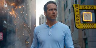 Ryan Reynolds walking through streets of destruction in Free Guy.