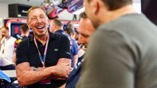 Larry Ellison talks with Red Bull Racing principal Christian Horner and Elon Musk in the Red Bull Racing garage ahead of the F1 Miami Grand Prix