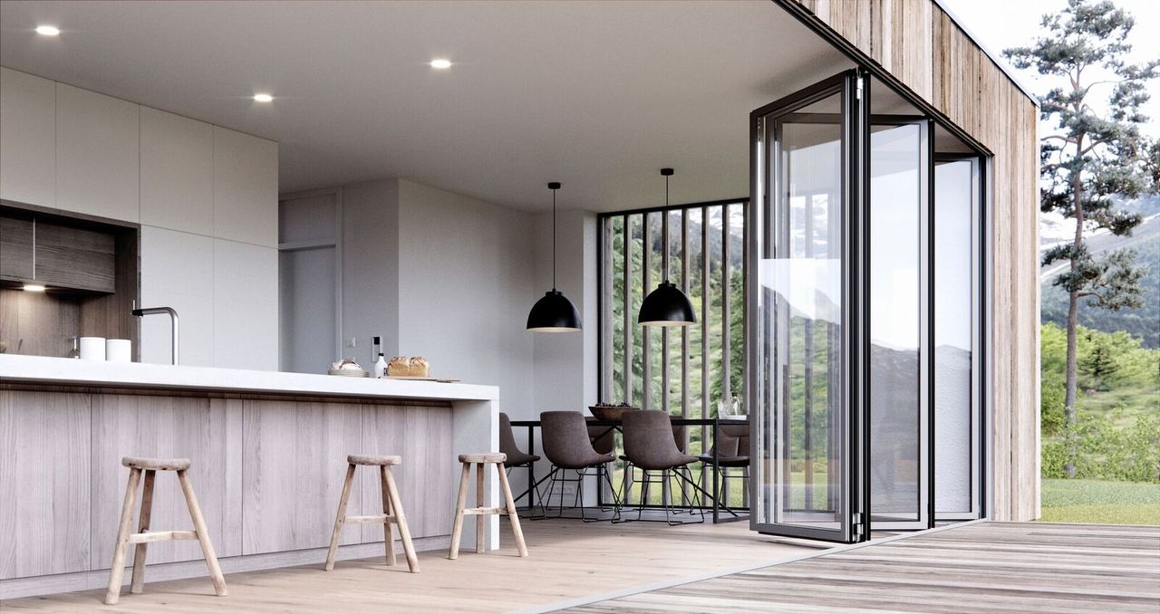 Bi-fold patio doors with black frame creates a view inside and out