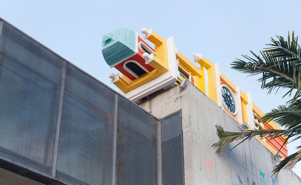 Concrete building with horizontal clock tower on top