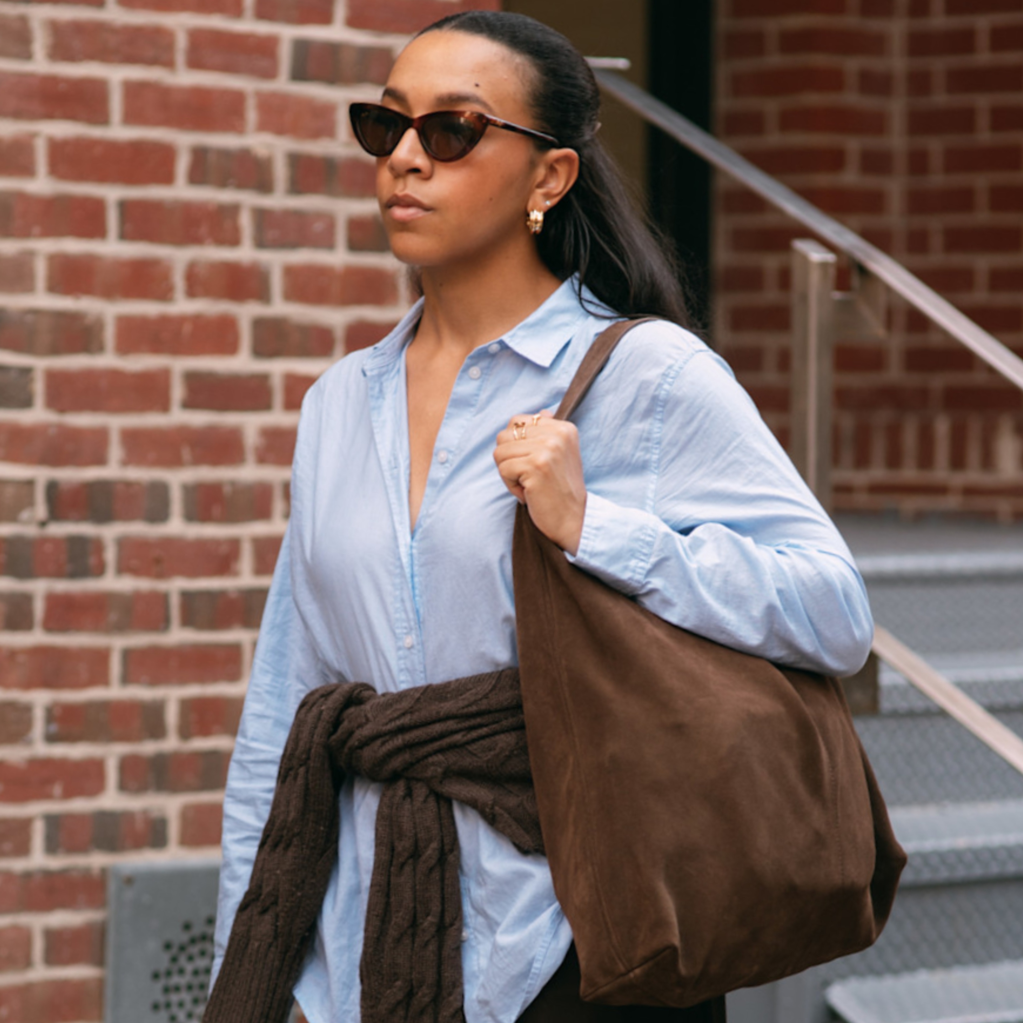 Lauren Tappan wearing blue top and brown pants