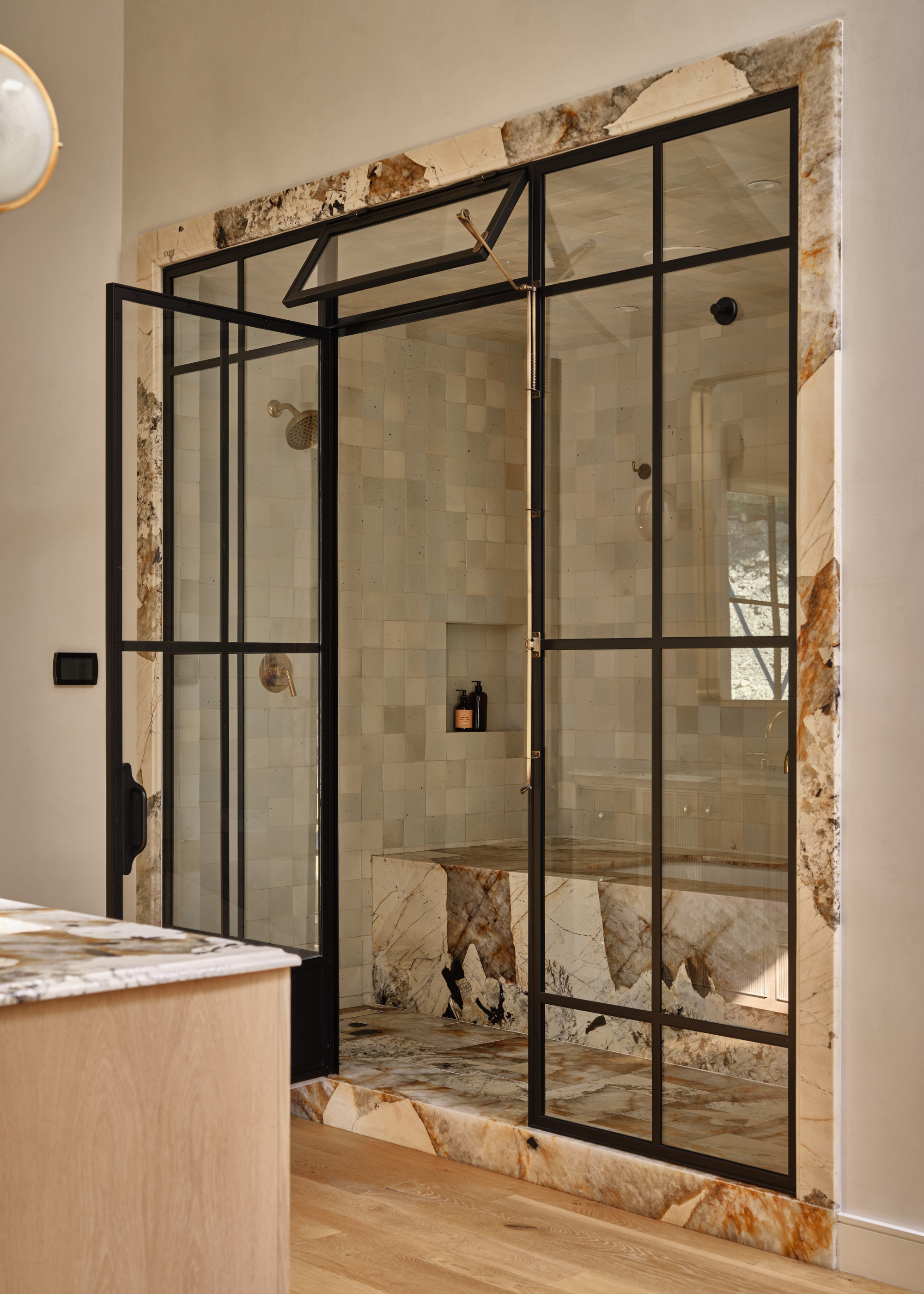 beautiful conservatory style shower with marble bench within and zellige tiles throughout