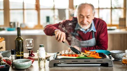 Senior man grilling vegan food