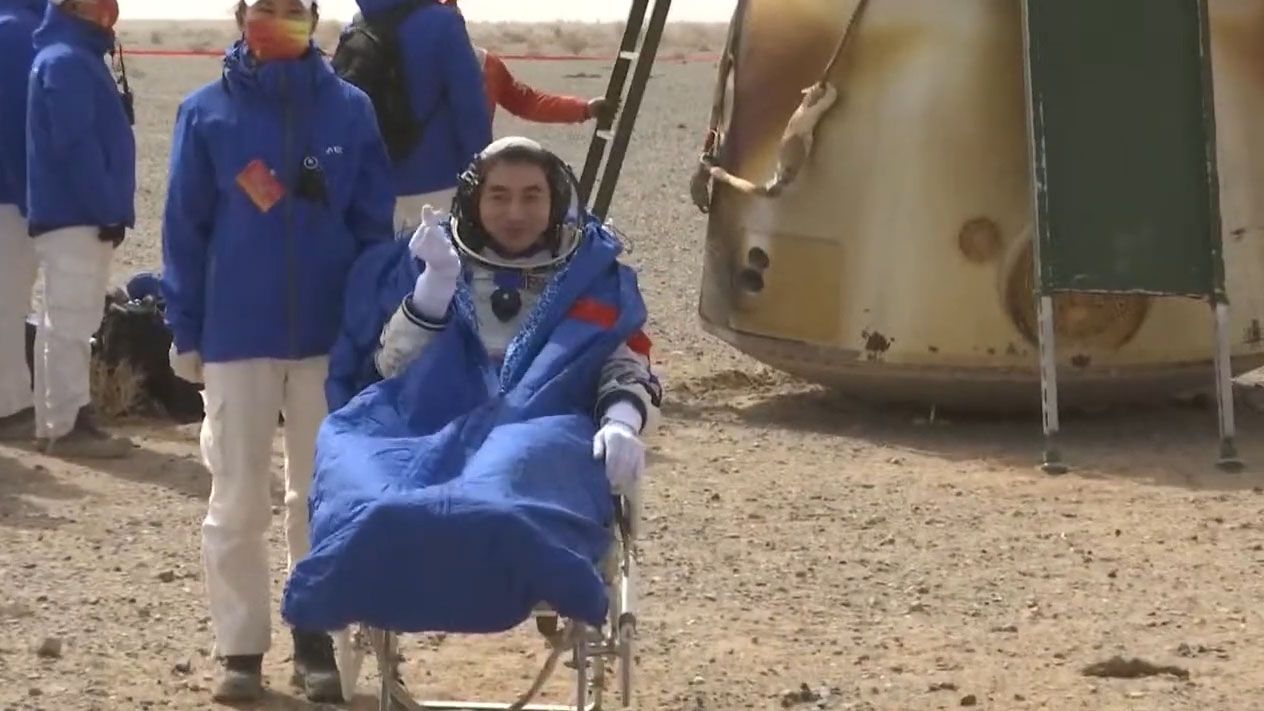 Astronaut Ye Guangfu of China's Shenzhou 13 mission makes a heart with his fingers after landing in the Gobi Desert on April 16, 2022. to end a record six-month mission on to the Tiangong space station.