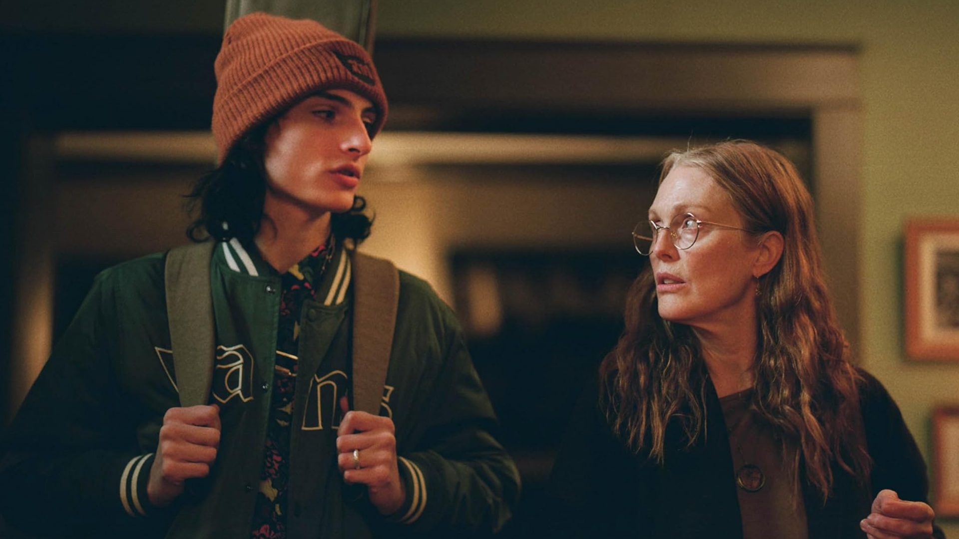 Finn Wolfhard and Julianne Moore look at each other