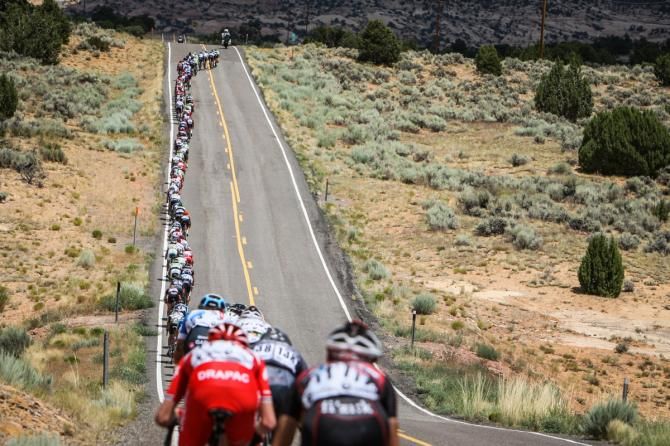 The peloton gets strung out to bring back the break