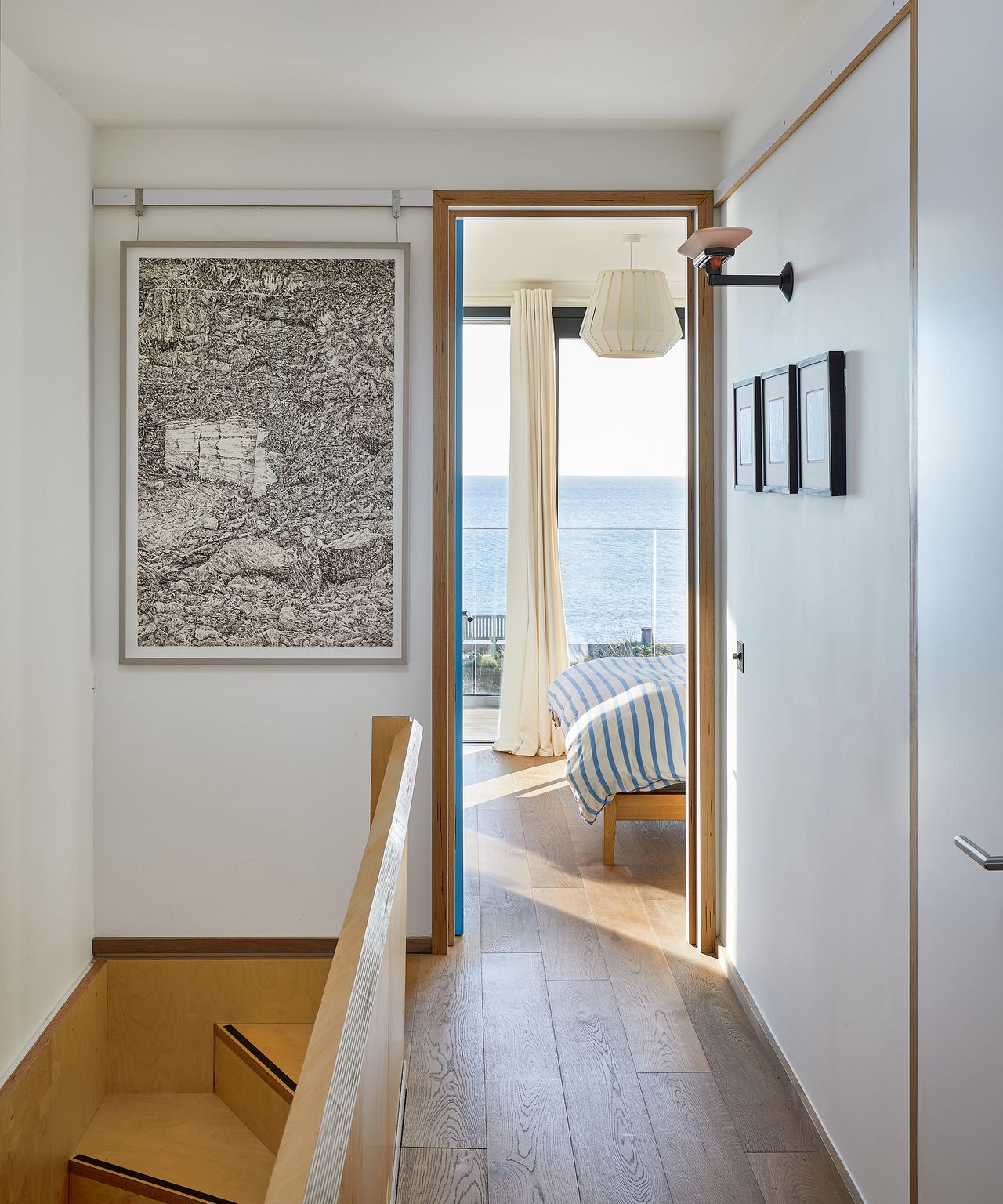 view down a landing into a bedroom with a seaview