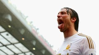 MANCHESTER, ENGLAND - MAY 12: Miguel Michu of Swansea City celebrates scoring his team's first goal to make the score 1-1 during the Barclays Premier League match between Manchester United and Swansea City at Old Trafford on May 12, 2013 in Manchester, England.