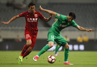 Burak Yilmaz (right) on the ball for Beijing Guoan against Shanghai SIPG in May 2017.