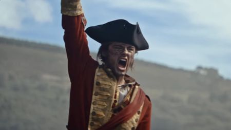 George Washington in military uniform and trifoil raising arm up victoriously in Young Washington