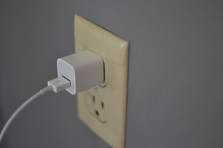 Plugging the USB wall adapter into a wall outlet