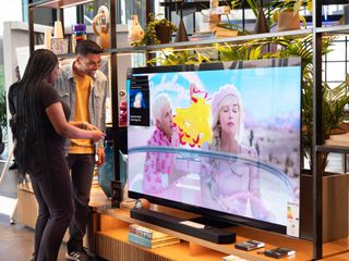 The 'Barbie' trailer playing on a Samsung OLED display in a retail store.