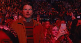 josh hartnett as a dad in the crowd of a concert in trap