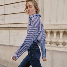 Zara model wearing striped button down shirt and jeans 