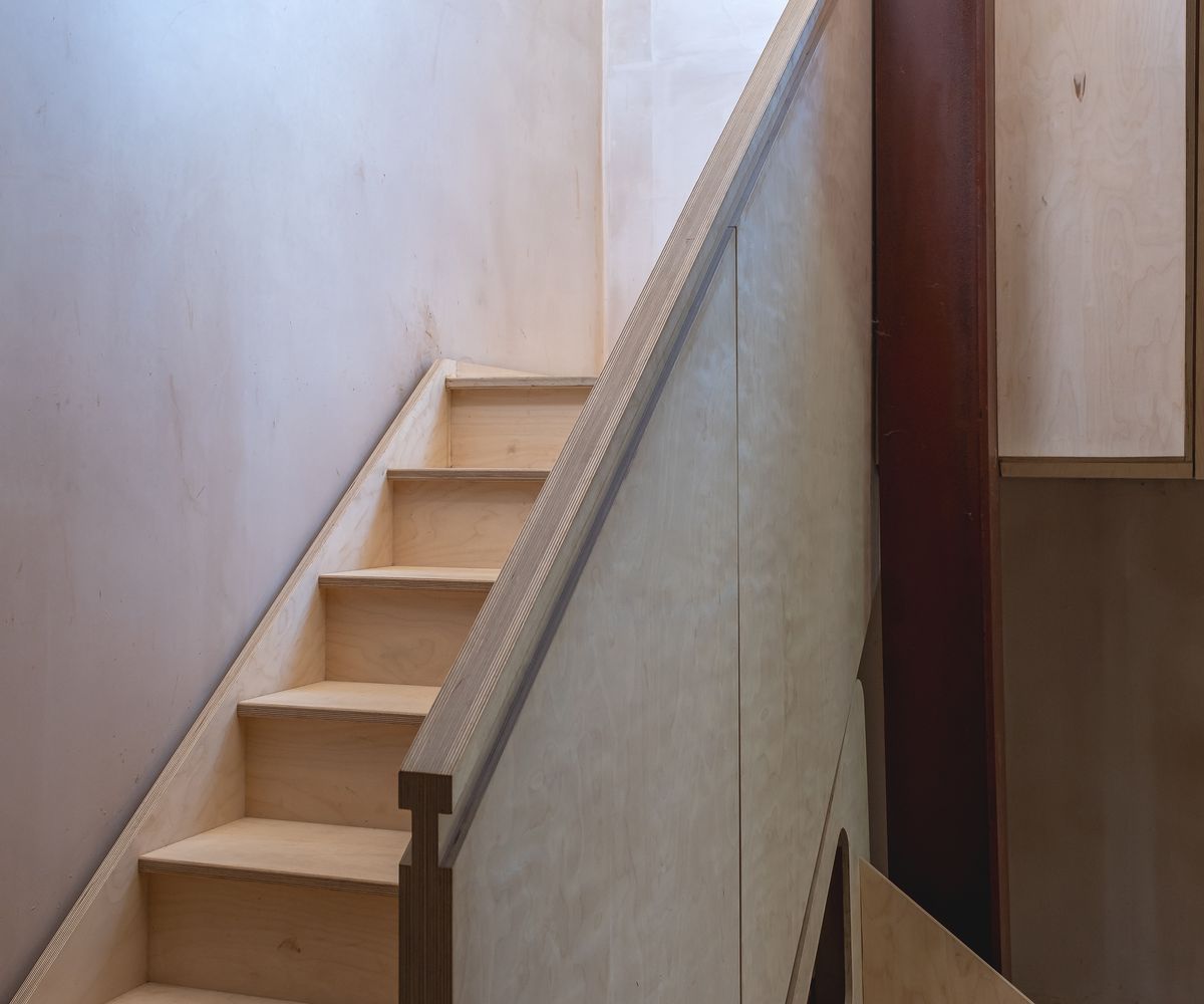 A timber staircase with everything in a very natural colour palette and exposed materials