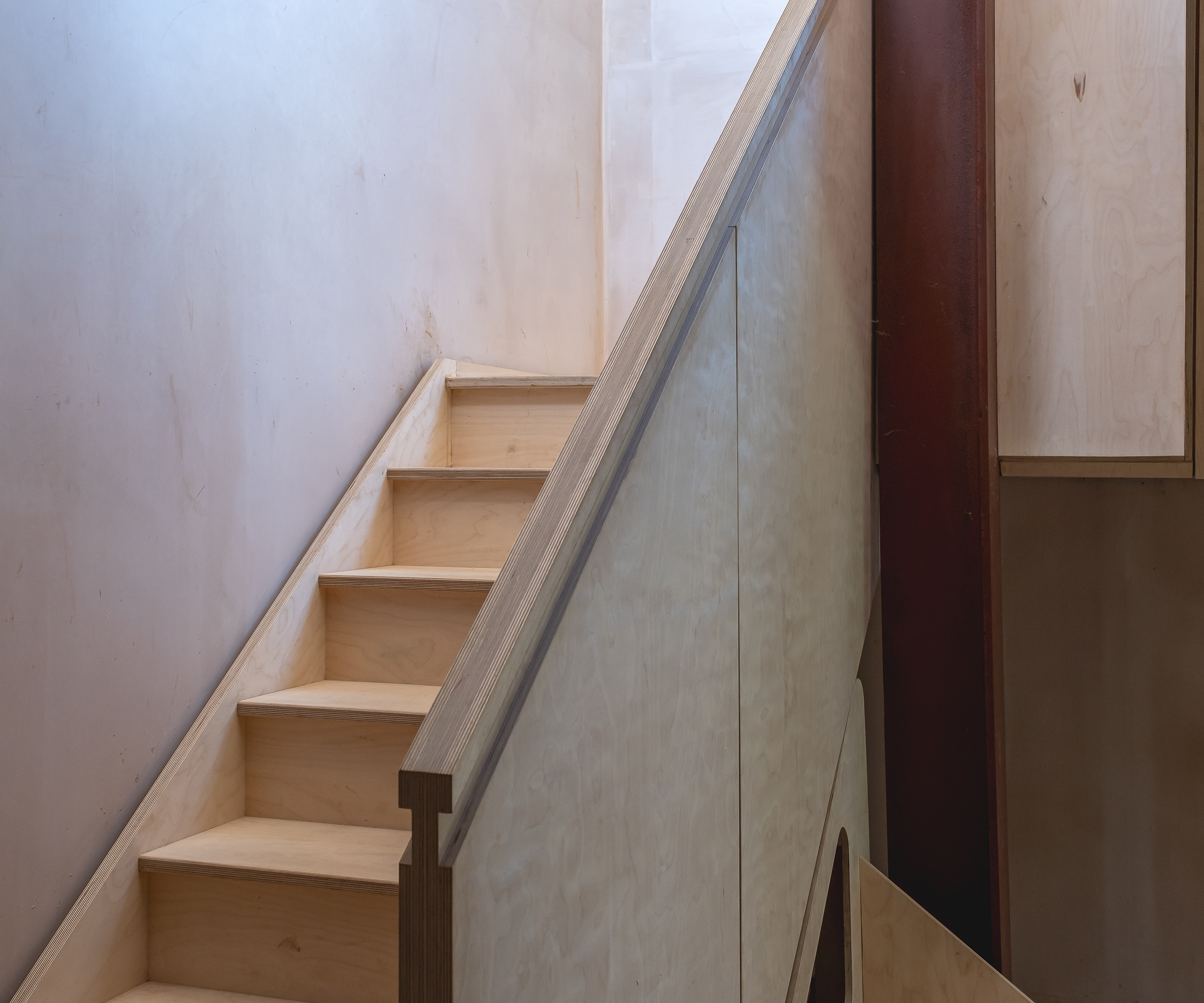 A timber staircase with everything in a very natural colour palette and exposed materials