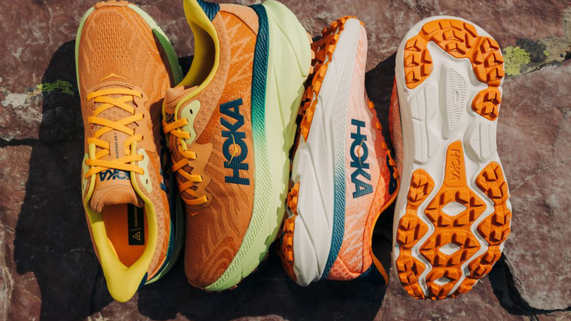 Two pairs of orange Hoka sneakers