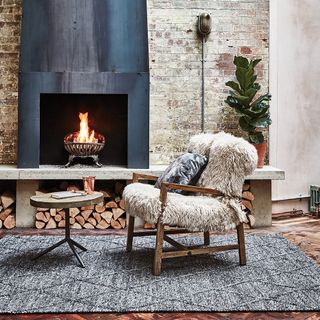 living room with exposed brick wall and grey fireplace