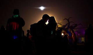 Silohuette of couple at a music festival