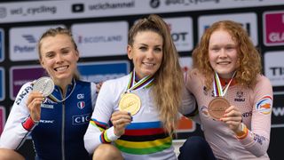 Loana Lecomte, Ferrand-Prévot and Pieterse showing medals on the podium at 2023 world champs