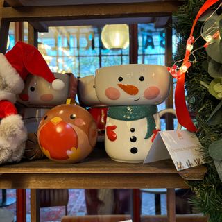 Snowman bowl and mug on wooden shelves