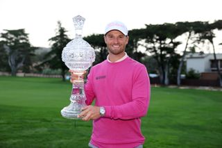 Wyndham Clark holds up the AT&T Pebble Beach Pro-Am trophy in 2024