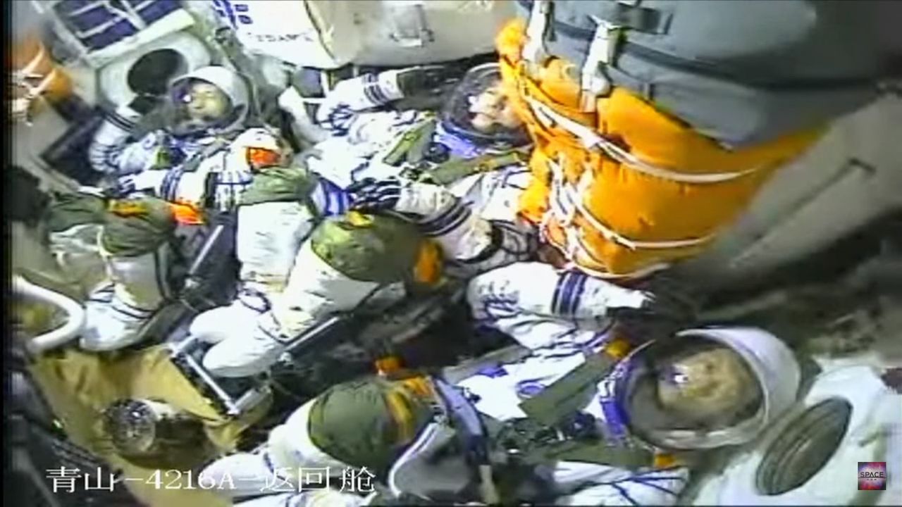 Three Chinese astronauts salute just before launching on the Shenzhou 16 mission