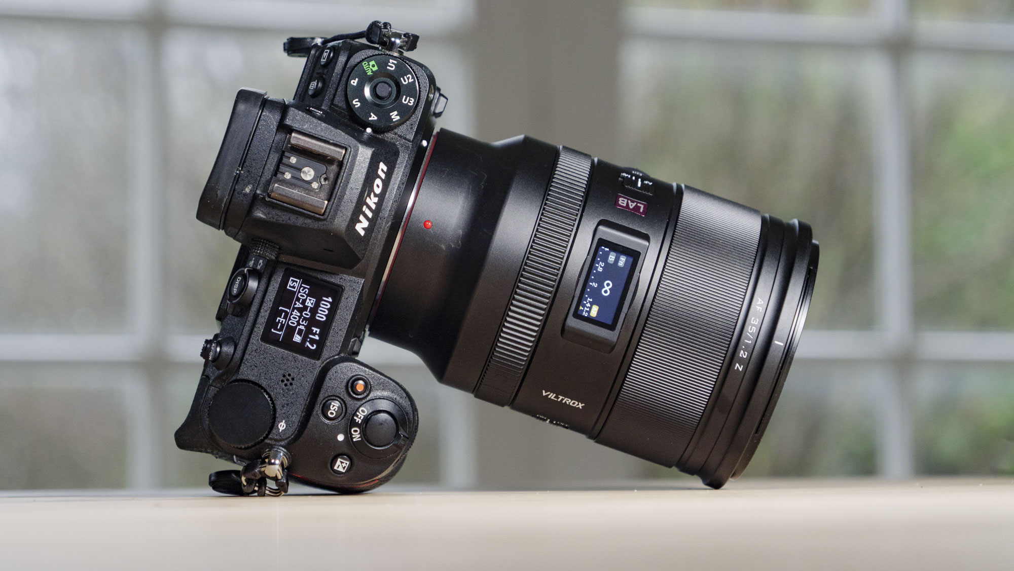 Viltrox AF 35mm F1.2 LAB Z lens for Nikon, attached to a Nikon Z6 II, on a wooden table