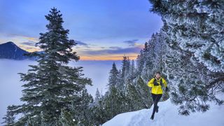 running in winter: trail runner in wintery landscape
