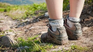 A person wearing hiking boots and wool socks