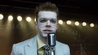 Jerome Velaska talking into microphone during Gotham Music Festival in Gotham.