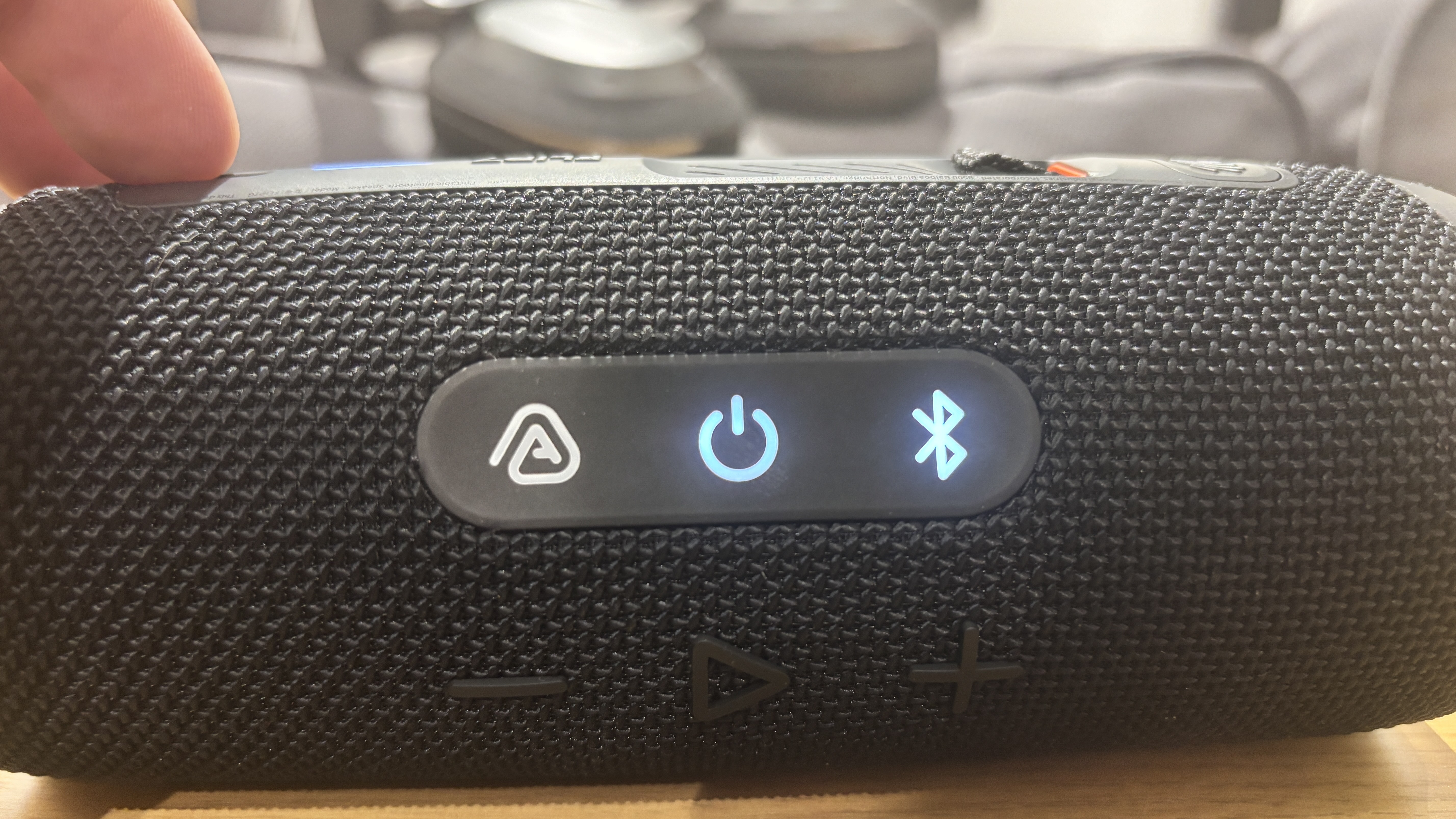 JBL Flip 7 closeup of buttons including Bluetooth and power