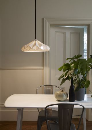 a statement sculptural light over a dining table