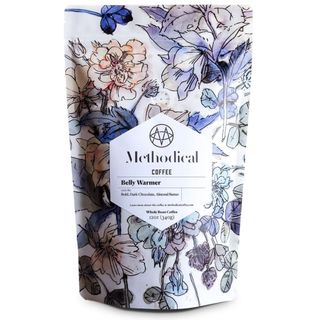 A bag of Methodical Coffee's Belly Warmer beans in pastel floral packaging