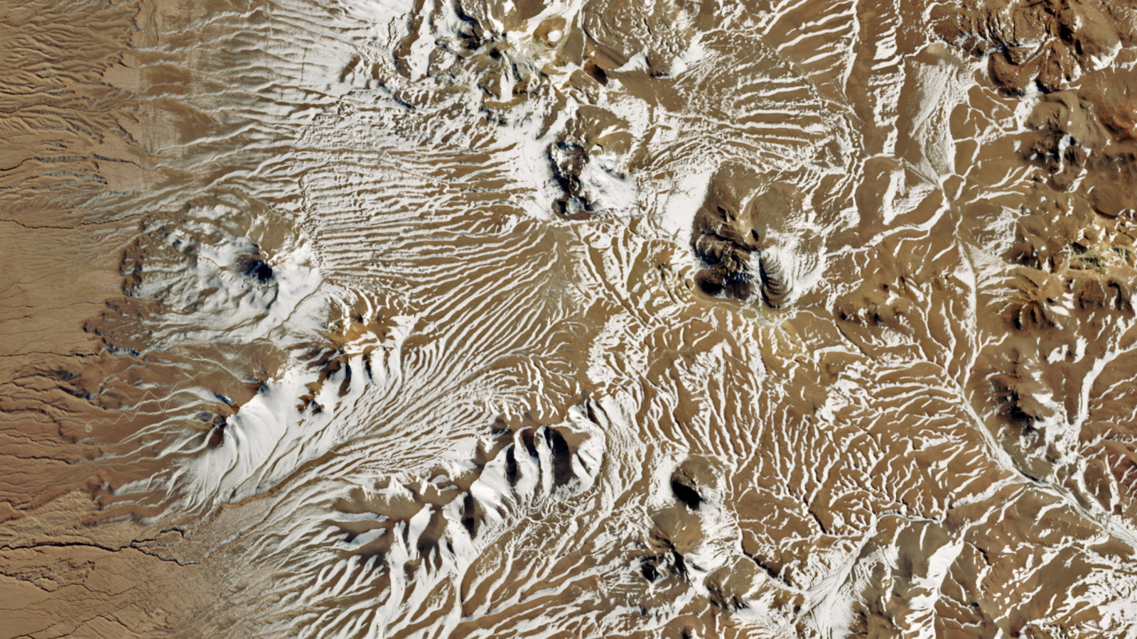 A zoomed-out map of the Atacama desert in Chile shows snow dotting hills and valleys. 