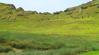 Other moai statues sit on the slopes of the Lake Rano Raraku crater lake.