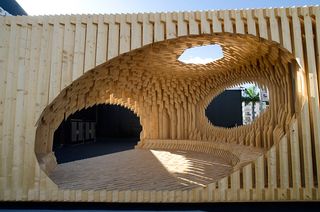 The triangular pavilion with vertical wooden planks
