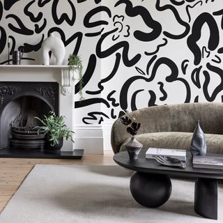 monochrome living room with painted wall effect on the fireplace wall