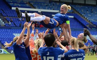 Katie Chapman being lifted by her Chelsea teammates