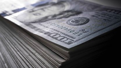 stack of hundred-dollar bills for stock buybacks